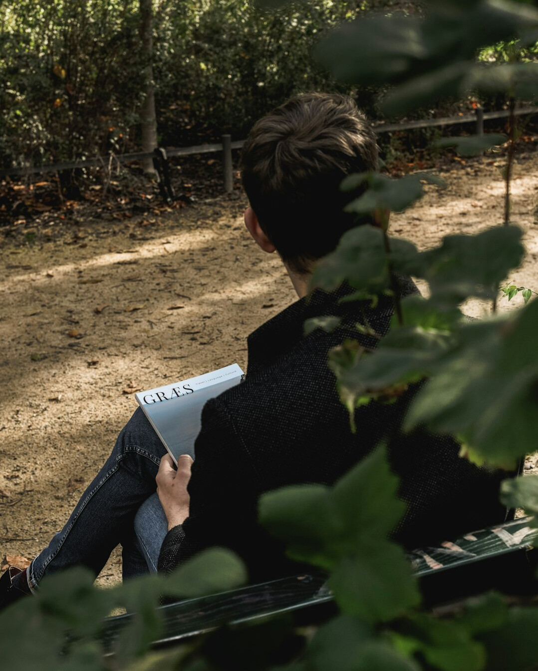 person writing in journal outdoors